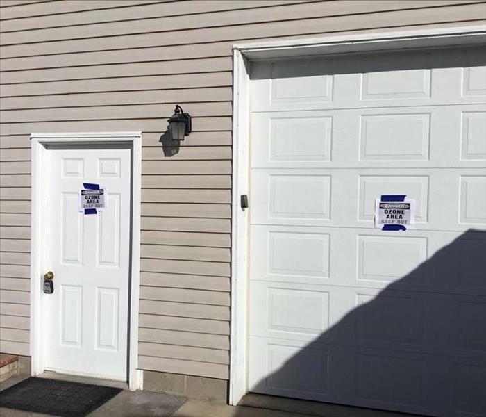 Ozone signes on door and garage of home