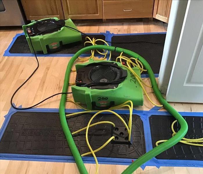 Green equipment on a wood floor