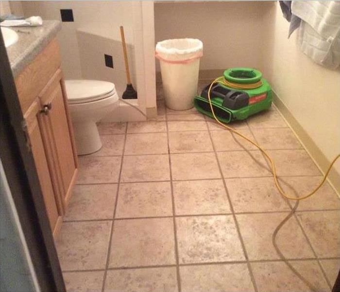 Image of SERVPRO's green drying equipment placed on bathroom floor